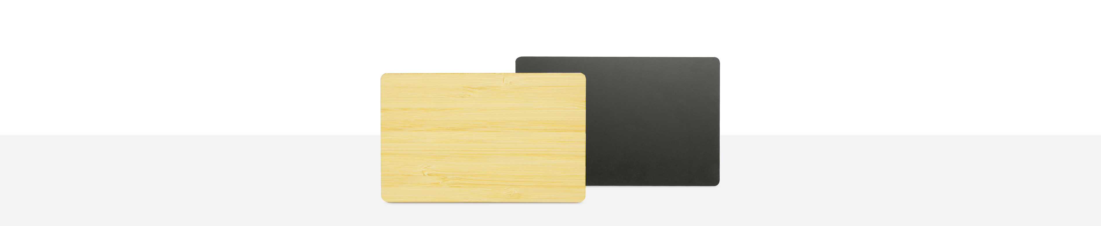 Wooden card next to a black metal card