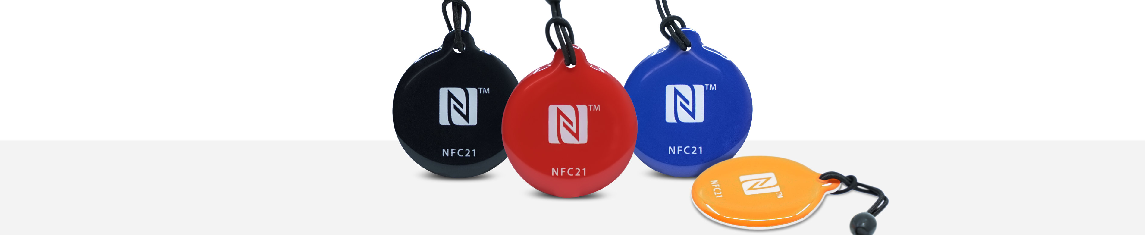 Epoxy key fob side by side in the colours black, red, blue and orange