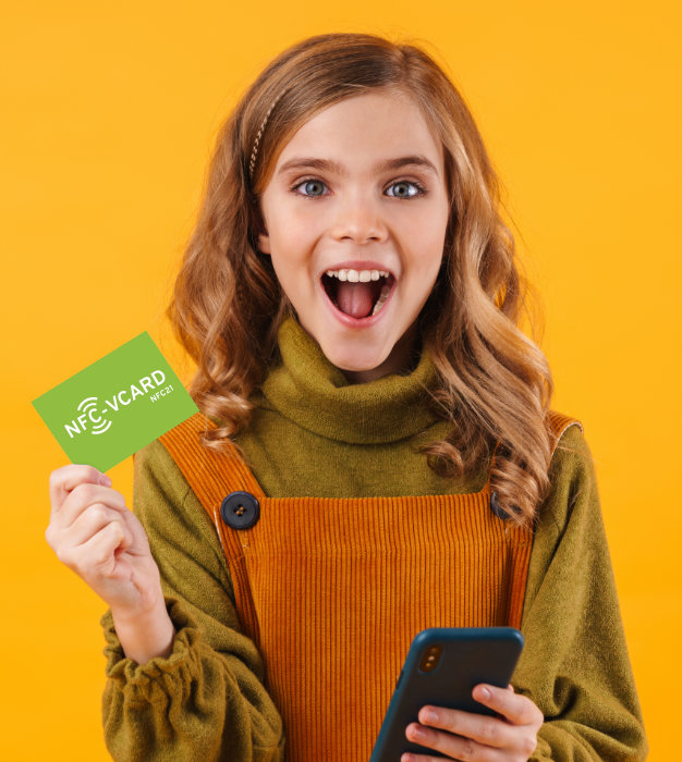 Girl with NFC vCard and smartphone in hand being happy